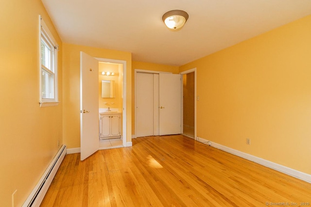123 Jeffrey Ln, Newington, CT 06111 - unfurnished bedroom featuring a baseboard heating unit, light wood-style flooring, baseboards, connected bathroom, and a closet