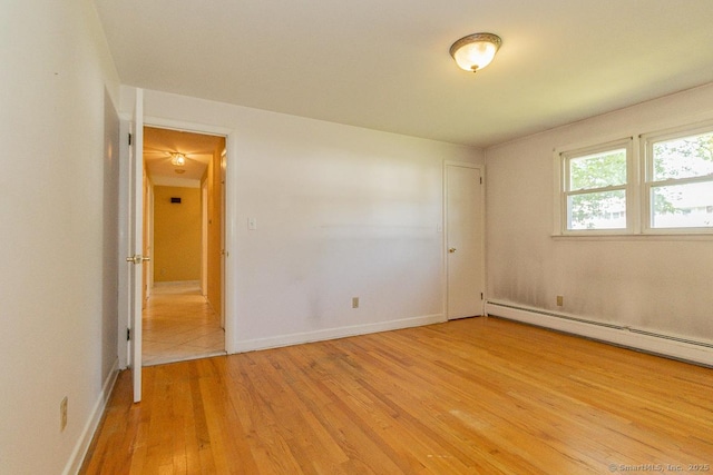123 Jeffrey Ln, Newington, CT 06111 - unfurnished room with a baseboard heating unit, light wood-style floors, and baseboards