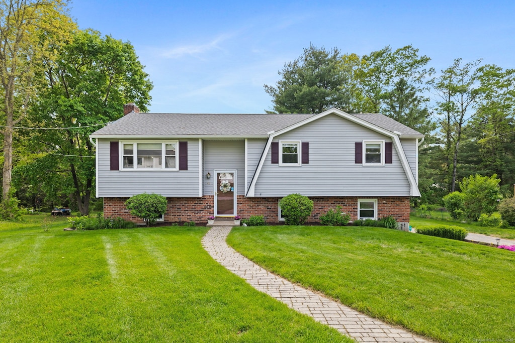 48 Flom Dr, Colchester, CT 06415 - raised ranch with a front yard, a chimney, and a shingled roof