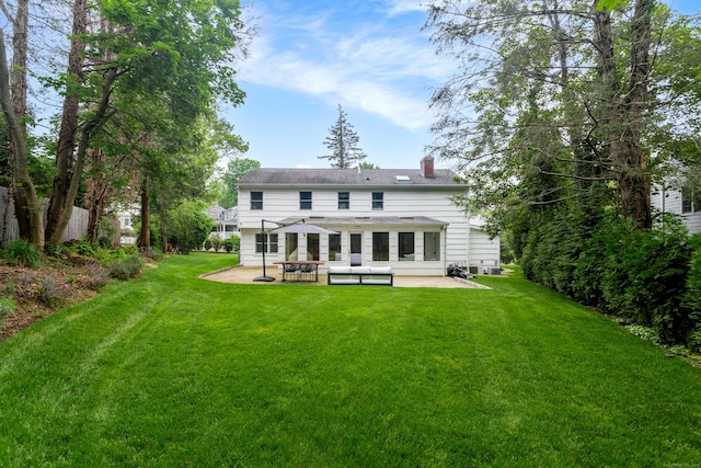 175 Riverside Ave, Greenwich, CT 06878 - back of property with a patio, a yard, and a chimney