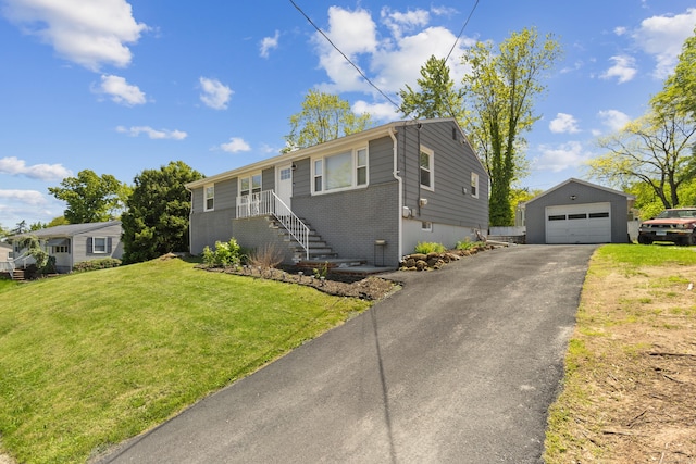 26 Carroll Rd, Hamden, CT 06517 - ranch-style home with a detached garage, driveway, brick siding, an outbuilding, and a front lawn