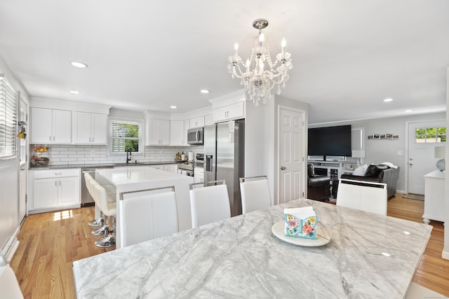 26 Carroll Rd, Hamden, CT 06517 - dining space with plenty of natural light, recessed lighting, light wood finished floors, and a chandelier