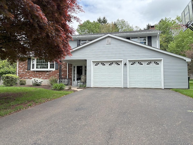 207 Pheasant Dr, Rocky Hill, CT 06067 - view of front of home with driveway, a chimney, brick siding, an attached garage, and a front yard