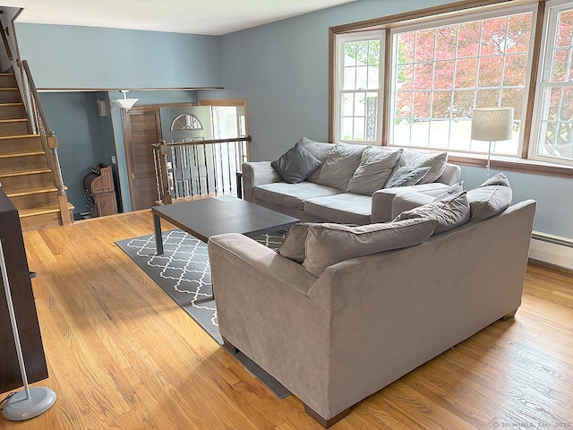 207 Pheasant Dr, Rocky Hill, CT 06067 - living area featuring light wood finished floors, stairs, and a baseboard radiator