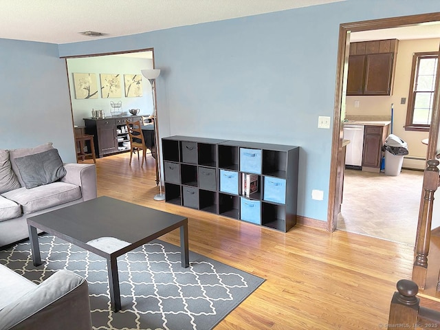 207 Pheasant Dr, Rocky Hill, CT 06067 - living room featuring light wood-type flooring, a baseboard radiator, and baseboards