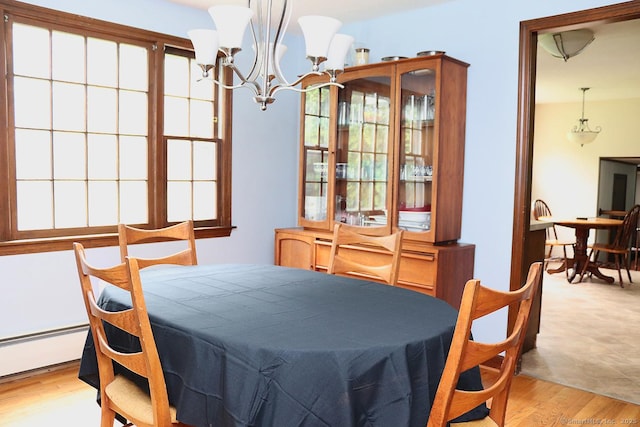 207 Pheasant Dr, Rocky Hill, CT 06067 - dining area with a chandelier, light wood-style floors, and baseboard heating