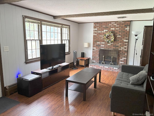 207 Pheasant Dr, Rocky Hill, CT 06067 - living room with a fireplace, beamed ceiling, a textured ceiling, healthy amount of natural light, and wood finished floors