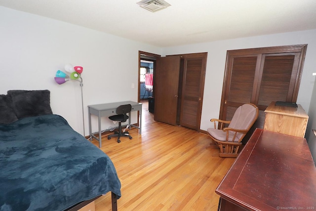 207 Pheasant Dr, Rocky Hill, CT 06067 - bedroom featuring light wood-type flooring and two closets