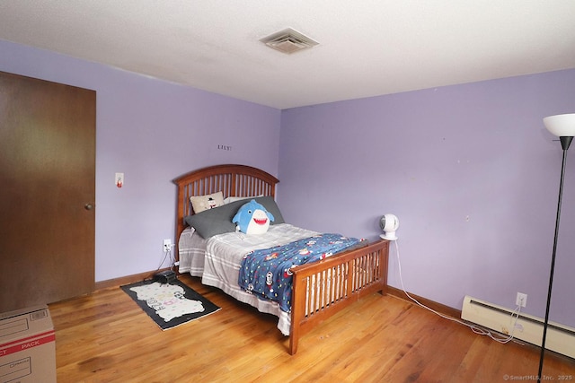 207 Pheasant Dr, Rocky Hill, CT 06067 - bedroom with a baseboard radiator, wood finished floors, and baseboards