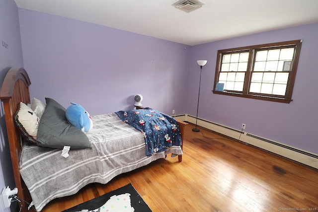 207 Pheasant Dr, Rocky Hill, CT 06067 - bedroom featuring wood finished floors and a baseboard heating unit