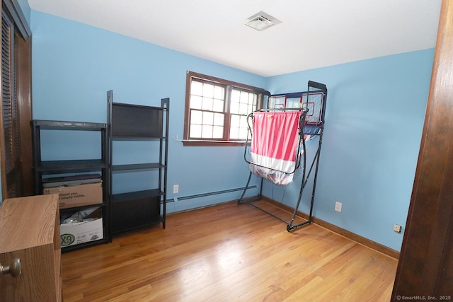 207 Pheasant Dr, Rocky Hill, CT 06067 - bedroom with baseboard heating, wood finished floors, and baseboards
