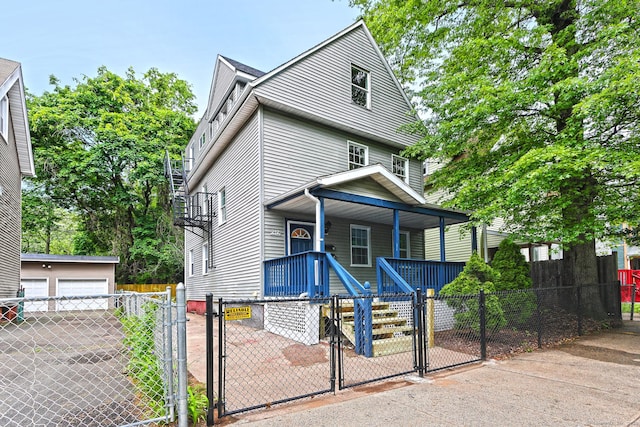 212 Newhall St, New Haven, CT 06511 - view of front of home featuring a porch, a gate, a fenced front yard, and a detached garage