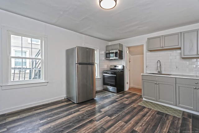 212 Newhall St, New Haven, CT 06511 - kitchen featuring appliances with stainless steel finishes, gray cabinetry, a sink, and dark wood finished floors