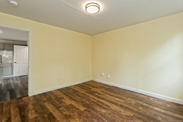 212 Newhall St, New Haven, CT 06511 - empty room with a smoke detector, dark wood finished floors, baseboards, and a sink