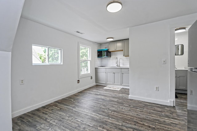 212 Newhall St, New Haven, CT 06511 - kitchen with gray cabinetry, a sink, tasteful backsplash, dark wood finished floors, and baseboards