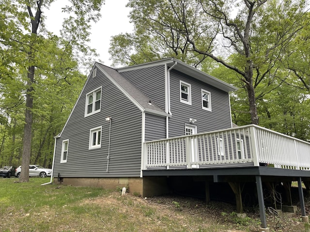rear view of property featuring a wooden deck