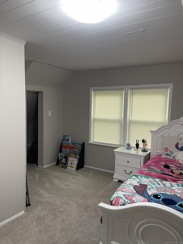 bedroom featuring carpet flooring, vaulted ceiling, and baseboards