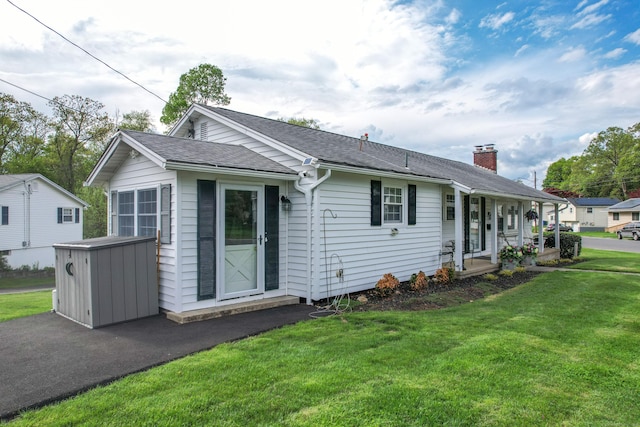 91 Parklawn Dr, Waterbury, CT 06708 - view of front of home with a front lawn, a chimney, covered porch, and a shingled roof