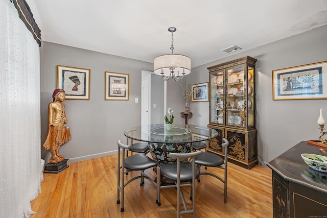91 Parklawn Dr, Waterbury, CT 06708 - dining area featuring a chandelier, light wood-style floors, and baseboards