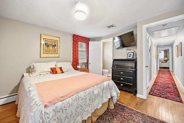 91 Parklawn Dr, Waterbury, CT 06708 - bedroom featuring wood finished floors, a baseboard heating unit, and baseboards