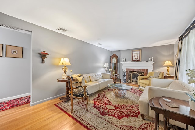 91 Parklawn Dr, Waterbury, CT 06708 - living room with wood finished floors, a brick fireplace, and baseboards