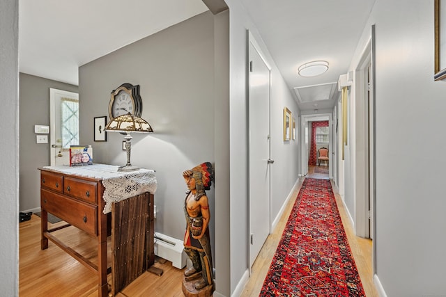 91 Parklawn Dr, Waterbury, CT 06708 - corridor featuring light wood finished floors, healthy amount of natural light, a baseboard heating unit, and baseboards