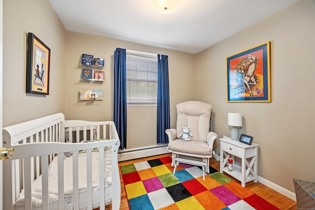 91 Parklawn Dr, Waterbury, CT 06708 - bedroom with a baseboard radiator, wood finished floors, a crib, and baseboards