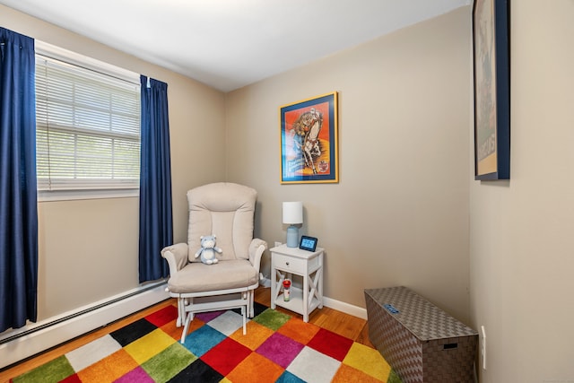 91 Parklawn Dr, Waterbury, CT 06708 - living area with baseboard heating, wood finished floors, and baseboards