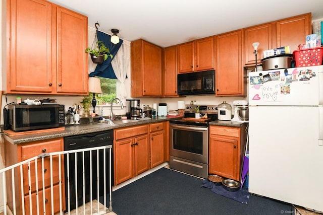 kitchen with freestanding refrigerator, black microwave, stainless steel range with electric stovetop, dishwashing machine, and a sink
