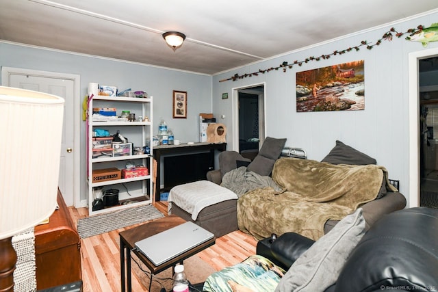 living area featuring wood finished floors and ornamental molding