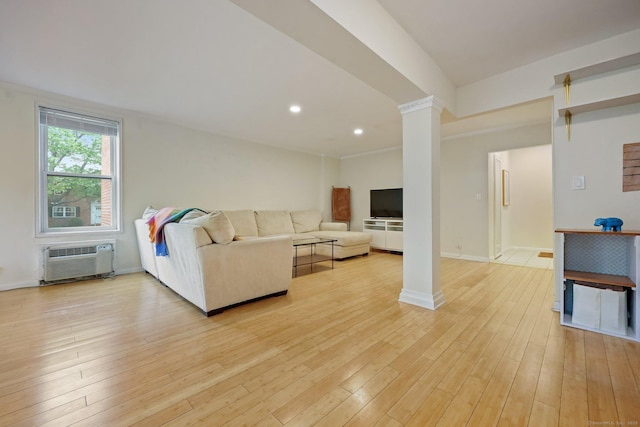 7 4th St Unit 1C, Stamford, CT 06905 - living room featuring a wall unit AC, light wood-type flooring, ornate columns, baseboards, and recessed lighting