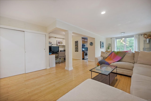 7 4th St Unit 1C, Stamford, CT 06905 - living room featuring wood finished floors, ornate columns, a desk, recessed lighting, and baseboards