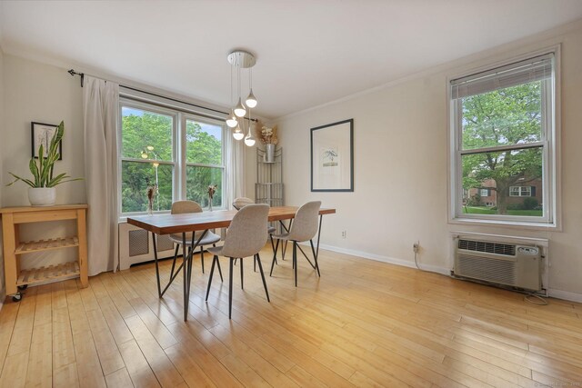 7 4th St Unit 1C, Stamford, CT 06905 - dining area featuring crown molding, plenty of natural light, baseboards, a wall mounted AC, and light wood finished floors