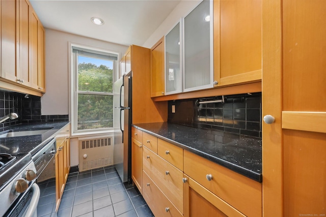 7 4th St Unit 1C, Stamford, CT 06905 - kitchen featuring radiator heating unit, stainless steel appliances, a sink, tile patterned flooring, and decorative backsplash