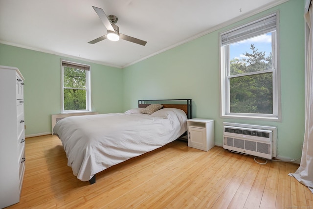 7 4th St Unit 1C, Stamford, CT 06905 - bedroom with crown molding, an AC wall unit, light wood-type flooring, ceiling fan, and baseboards