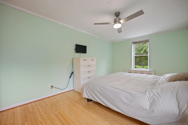 7 4th St Unit 1C, Stamford, CT 06905 - bedroom with crown molding, light wood finished floors, baseboards, and a ceiling fan