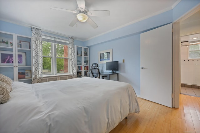 7 4th St Unit 1C, Stamford, CT 06905 - bedroom with multiple windows, ornamental molding, light wood-style flooring, ceiling fan, and ensuite bathroom