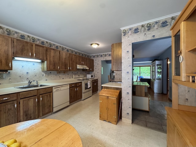 227 Twin Lakes Rd Apt C, North Branford, CT 06471 - kitchen with white appliances, a sink, wallpapered walls, light countertops, and under cabinet range hood