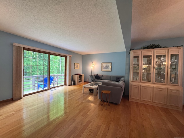 227 Twin Lakes Rd Apt C, North Branford, CT 06471 - living area featuring a textured ceiling and light wood finished floors
