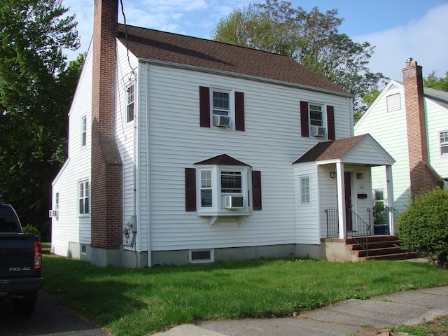 566 Savoy St, Bridgeport, CT 06606 - view of front of property with a front yard, a chimney, cooling unit, and roof with shingles