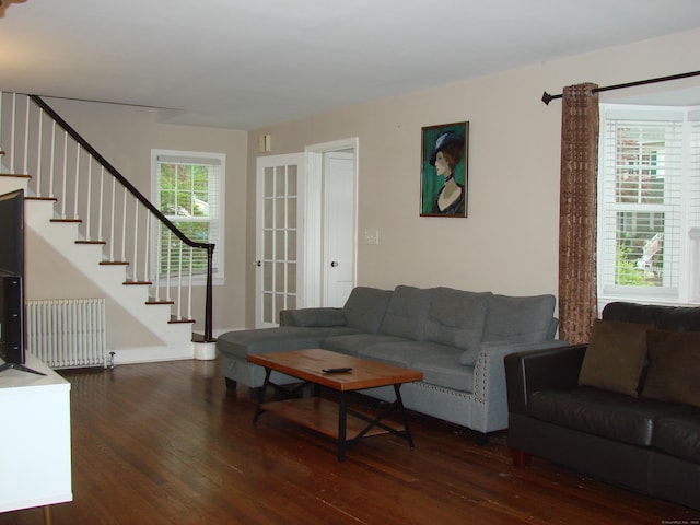 566 Savoy St, Bridgeport, CT 06606 - living room with radiator heating unit, wood finished floors, and stairway