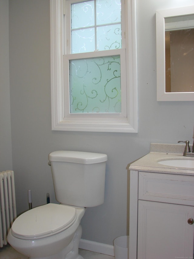 566 Savoy St, Bridgeport, CT 06606 - half bath with radiator, toilet, vanity, and baseboards
