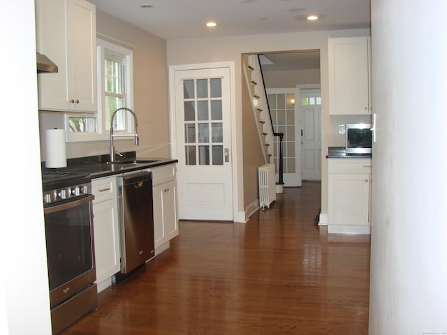 566 Savoy St, Bridgeport, CT 06606 - kitchen with stainless steel appliances, radiator, a sink, dark countertops, and recessed lighting