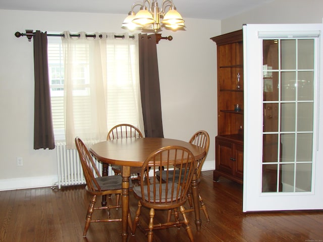 566 Savoy St, Bridgeport, CT 06606 - dining space featuring a chandelier, dark wood-style floors, and baseboards