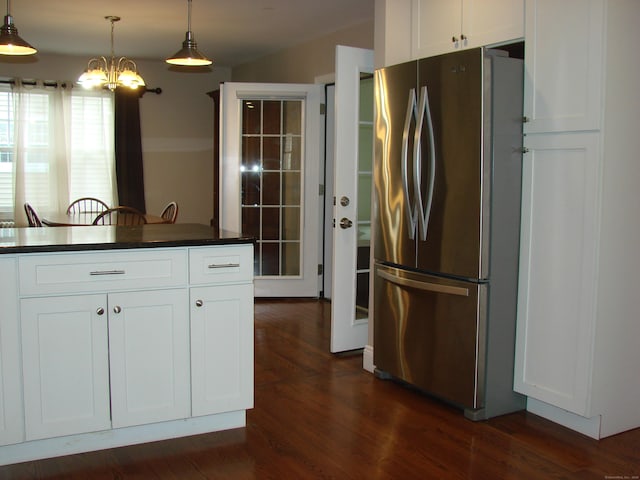 566 Savoy St, Bridgeport, CT 06606 - kitchen with freestanding refrigerator, dark countertops, a chandelier, white cabinetry, and dark wood-type flooring