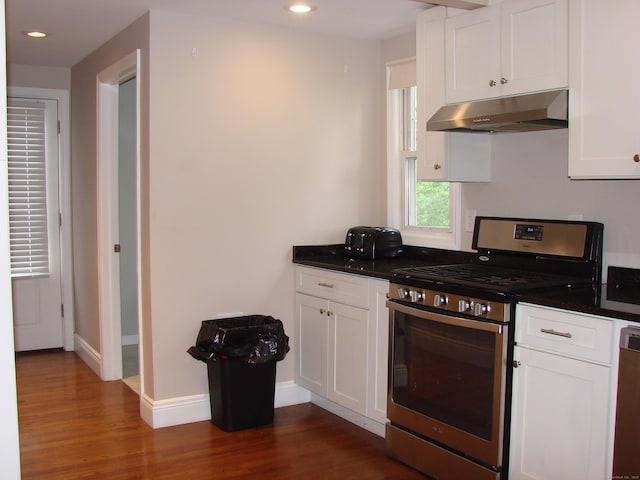 566 Savoy St, Bridgeport, CT 06606 - kitchen featuring appliances with stainless steel finishes, under cabinet range hood, dark wood finished floors, dark countertops, and recessed lighting