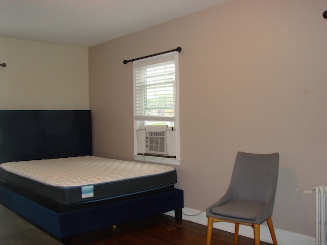 566 Savoy St, Bridgeport, CT 06606 - bedroom featuring radiator, wood finished floors, cooling unit, and baseboards