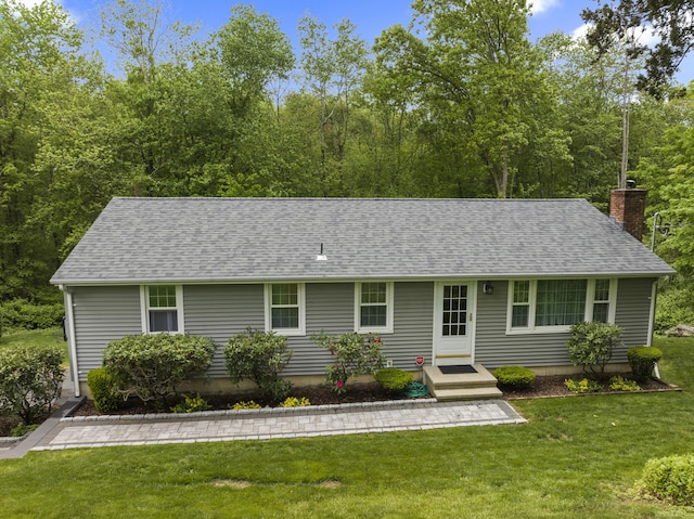 134 W Lake Ave, Guilford, CT 06437 - view of front of home with a chimney, roof with shingles, and a front yard
