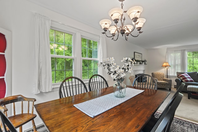 134 W Lake Ave, Guilford, CT 06437 - dining area featuring plenty of natural light, a chandelier, a fireplace, and carpet