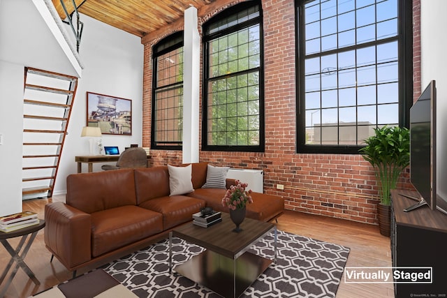 25 Grand St Apt 102, Norwalk, CT 06851 - living room featuring wood ceiling, brick wall, wood finished floors, and a high ceiling